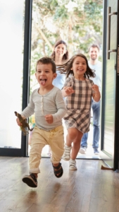 Happy family entering home